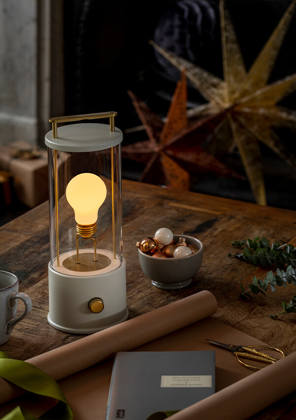 The Muse Portable Table Lamp by Tala x Farrow & Ball on a coffee table with festive decorations