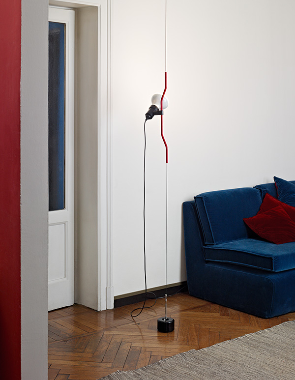 Flos Parentesi lamp next to a blue sofa