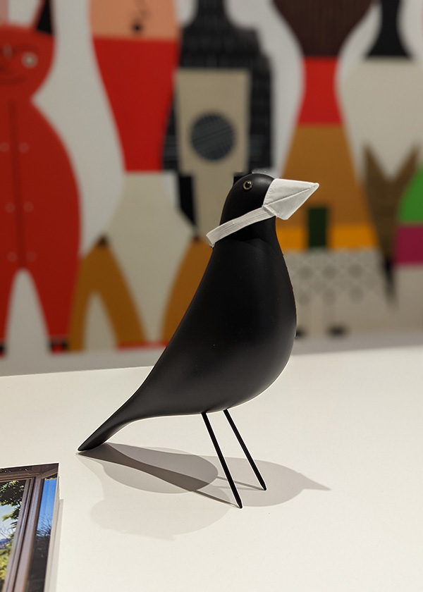 A Vitra Eames House Bird wearing a miniature mask