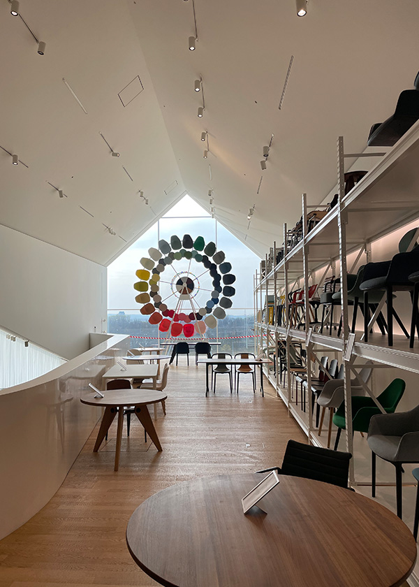 Looking toward a circle of chairs in the window of the VitraHaus