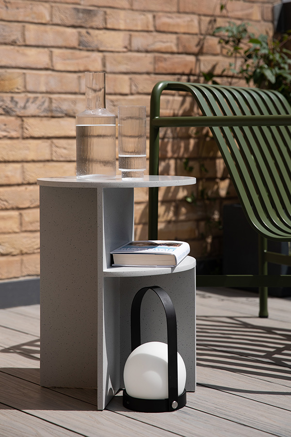 Muuto Halves Side Table, Menu Carrie Lamp and Ferm Living Ripple glasses being used outside