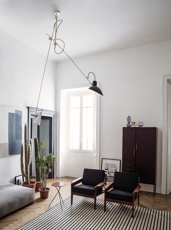 A Cinquanta suspension light in a mid-century style living room