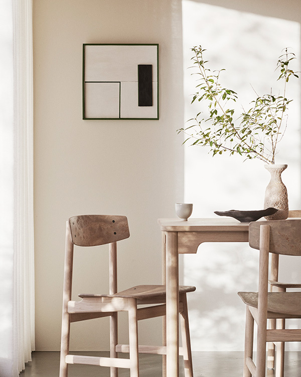 Two Mater Borge Mogensen Conscious Chair around a dining table in a neutral room