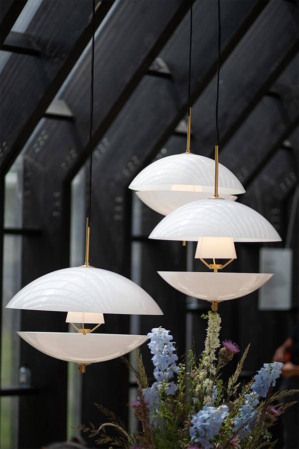 A cluster of Fritz Hansen Clam Pendants hanging inside the Fritz Hansen Pavillion