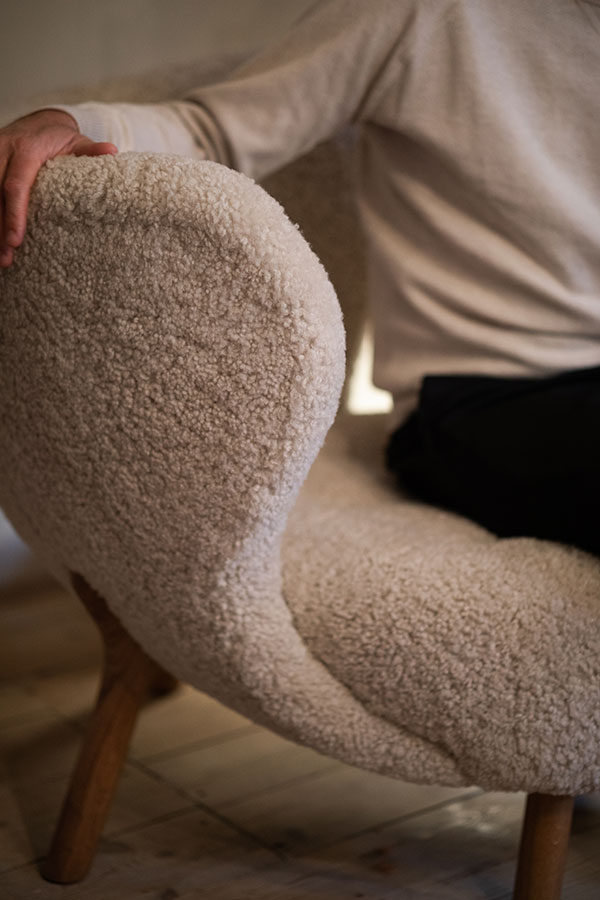 A close up of the &Tradition Little Petra Lounge Chair in sheepskin