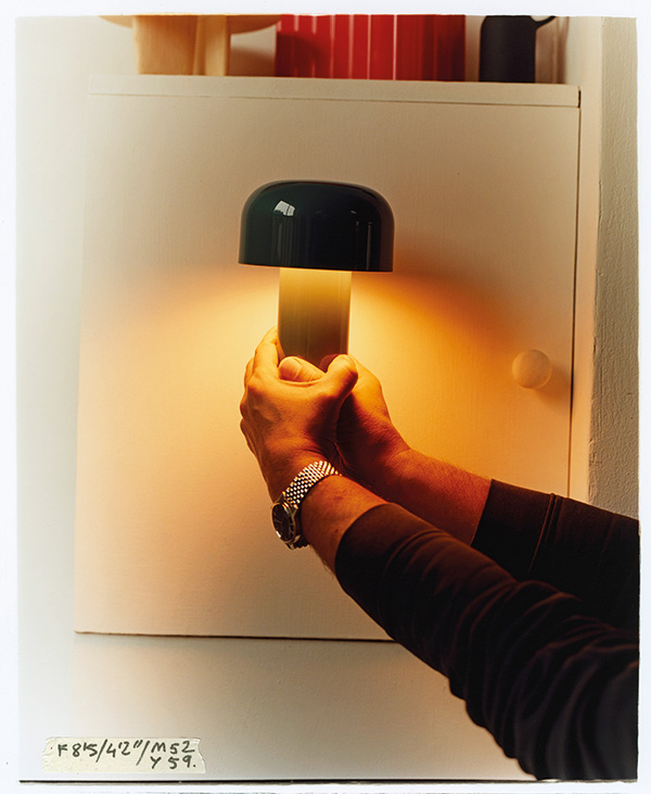 Someone holding up the Flos Bellhop Table Lamp