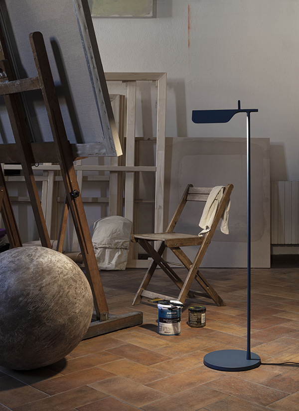 Blue Flos Tab Floor Lamp next to an artists easel