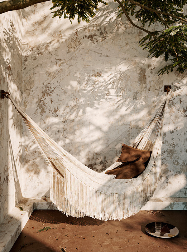 The ferm living Path Hammock hung under a tree