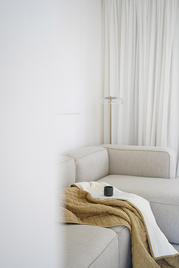 Look round the corner at a neutral corner sofa with a blanket