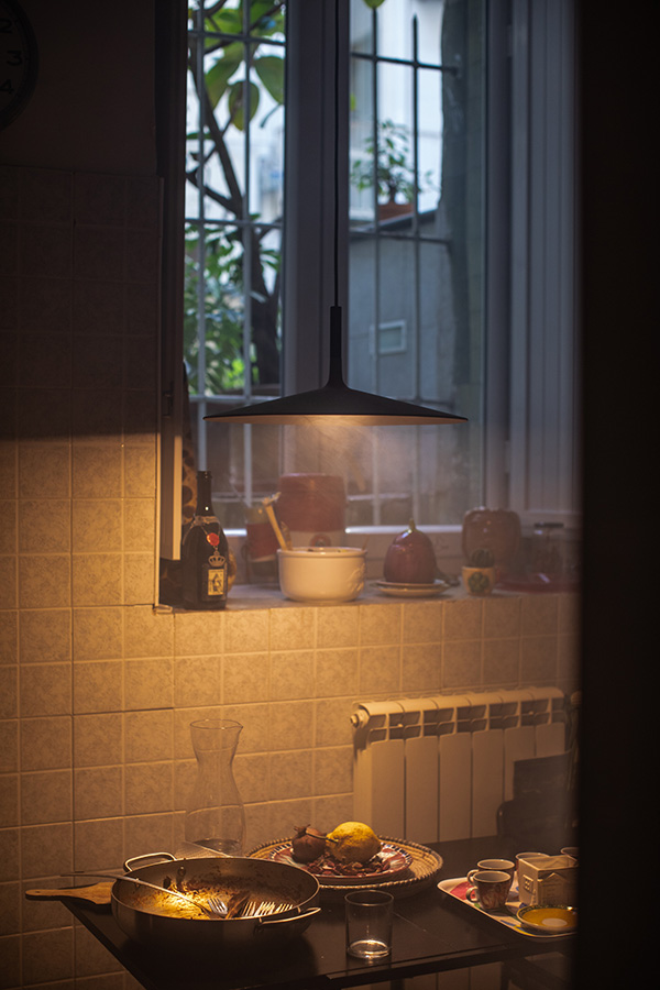 The Foscarini Aplomb Pendant casting a glow above a kitchen table