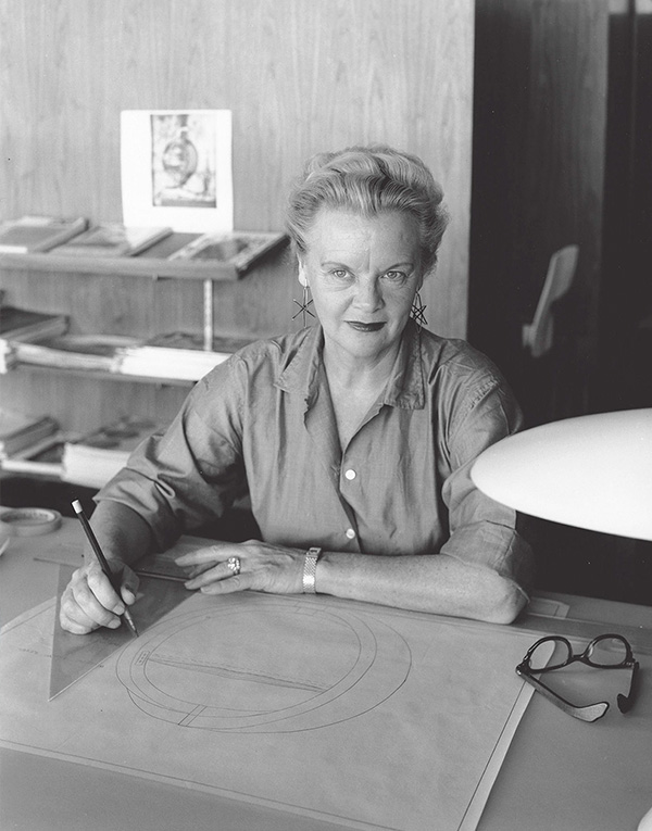 A black and white photo of Greta Grossman at her desk