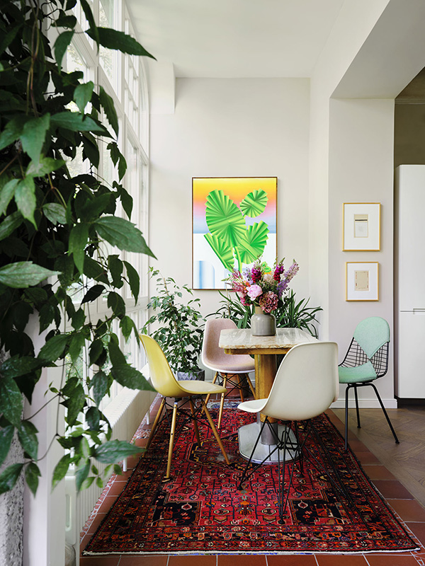 Colourful Eames Shell Chairs around a dining table
