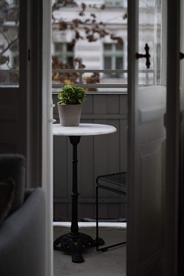 looking out through a door onto a small balcony
