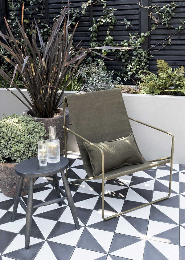An Olive Desert Lounge chair from ferm LIVING in Justin Coakley's garden