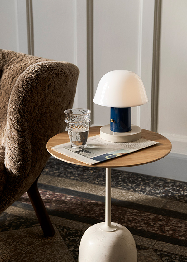 andTradition Lato table next to a sheepskin lounge chair