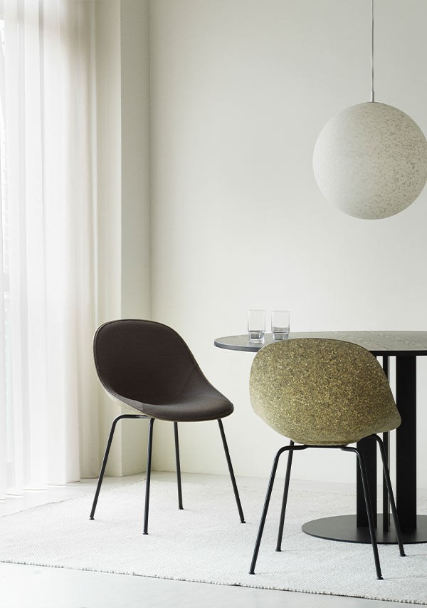 A pair of Normann Copenhagen Mat Chairs at dining table