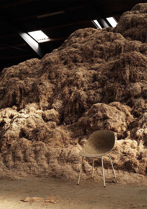 Normann Copenhagen Mat Chair in front of a dried hemp pile