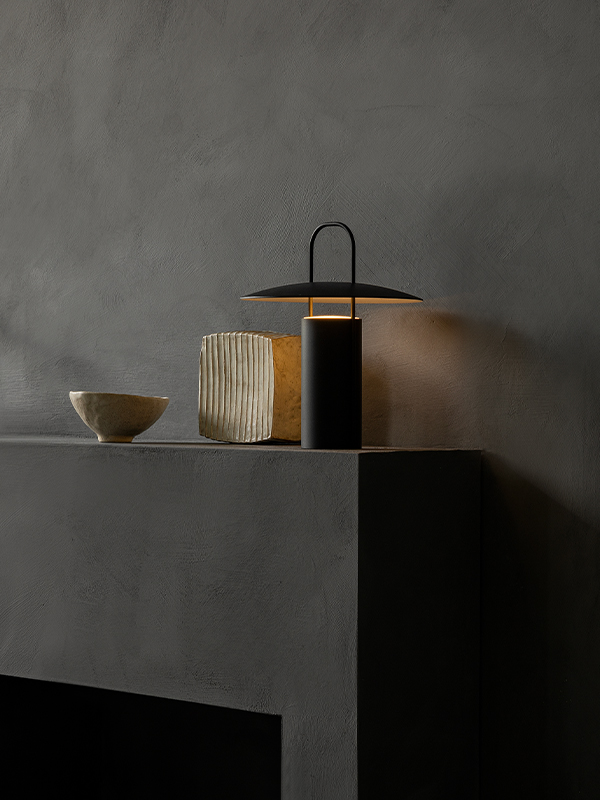 Audo Copenhagen Ray Portable Table Lamp on a fireplace