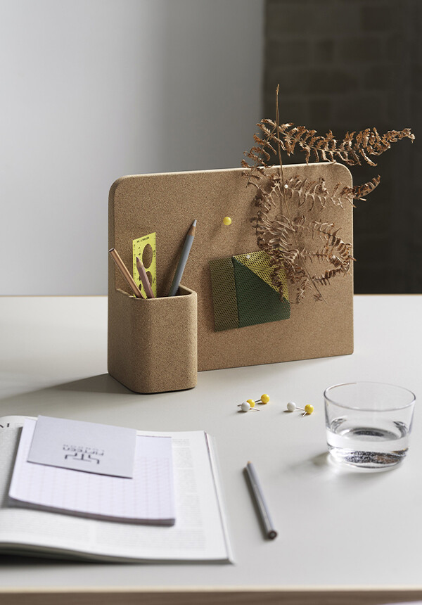 Notes, foliage and pens stored on Muuto Story Pinboard