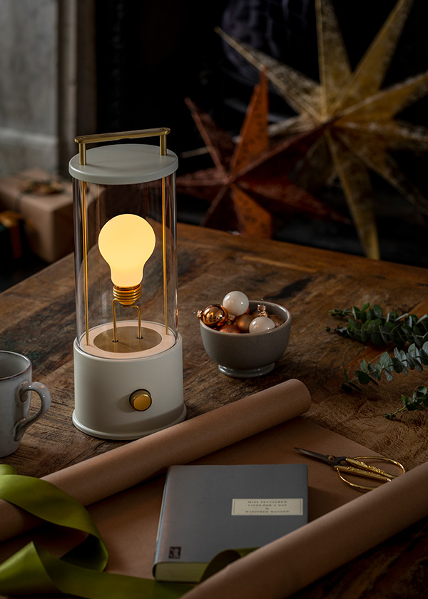 A Tala The Muse portable table lamp on a wooden table