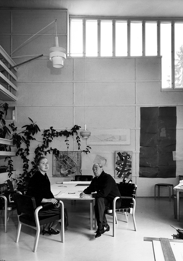 Elissa and Alvar Aalto sitting a table inside their house