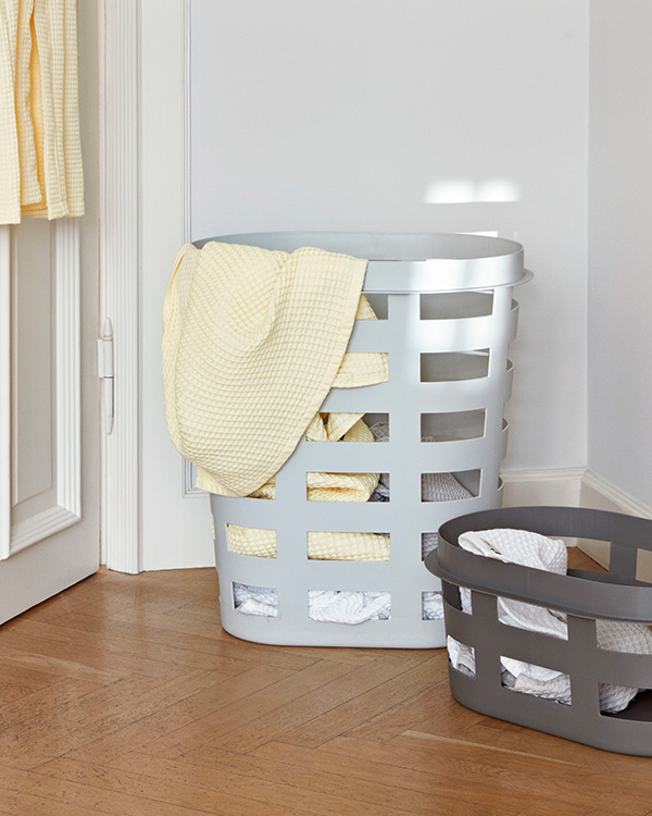 A HAY Laundry Basket with a yellow towel