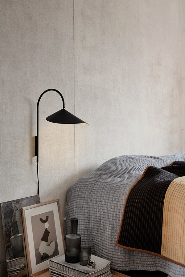 Ferm Living Arum Wall Lamp next to a neutral bed