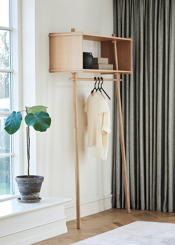 Oak Woud Tojbox Clothes Rack next to a plant on a windowsill