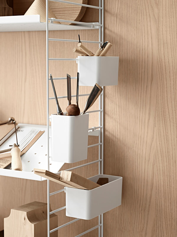 Hang things on the sides of the String shelving system for extra storage