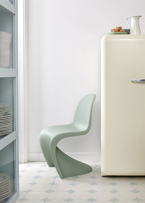 a light blue Vitra Panton Chair next to a fridge