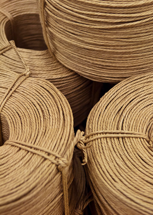 A close up of a pile of paper cord, used to weave the seat of the CH24 Wishbone Chair