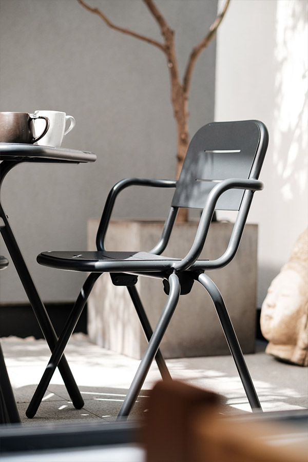 Woud Ray Outdoor Dining Chair in a sunny courtyard