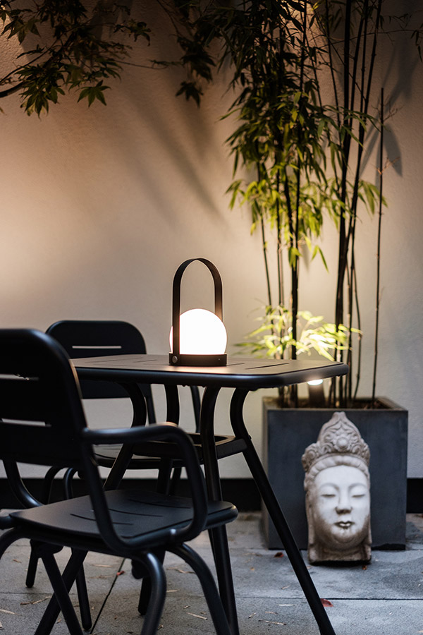 Audo Carrie Table Lamp on a Woud Ray Outdoor Table