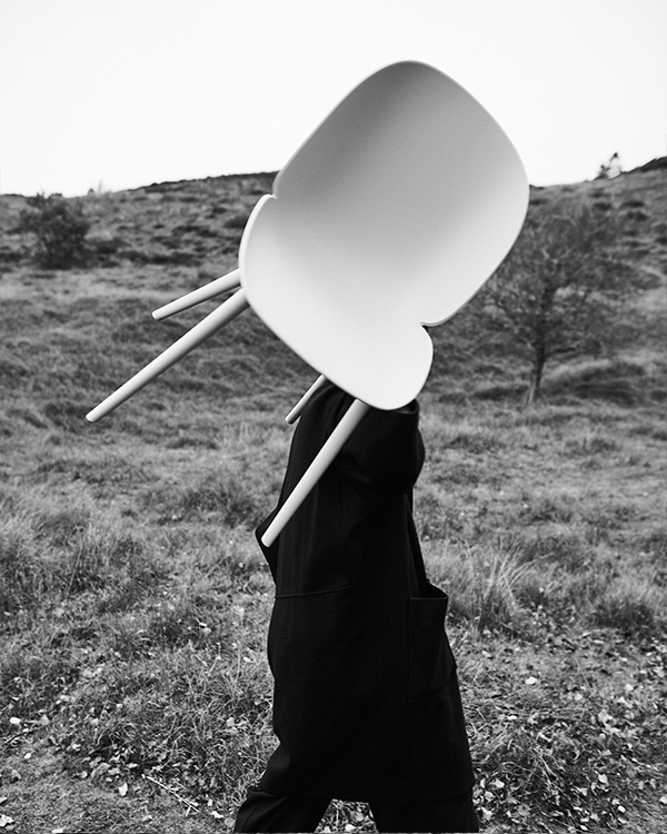 Stine Gam carrying a Beetle Outdoor Dining Chair