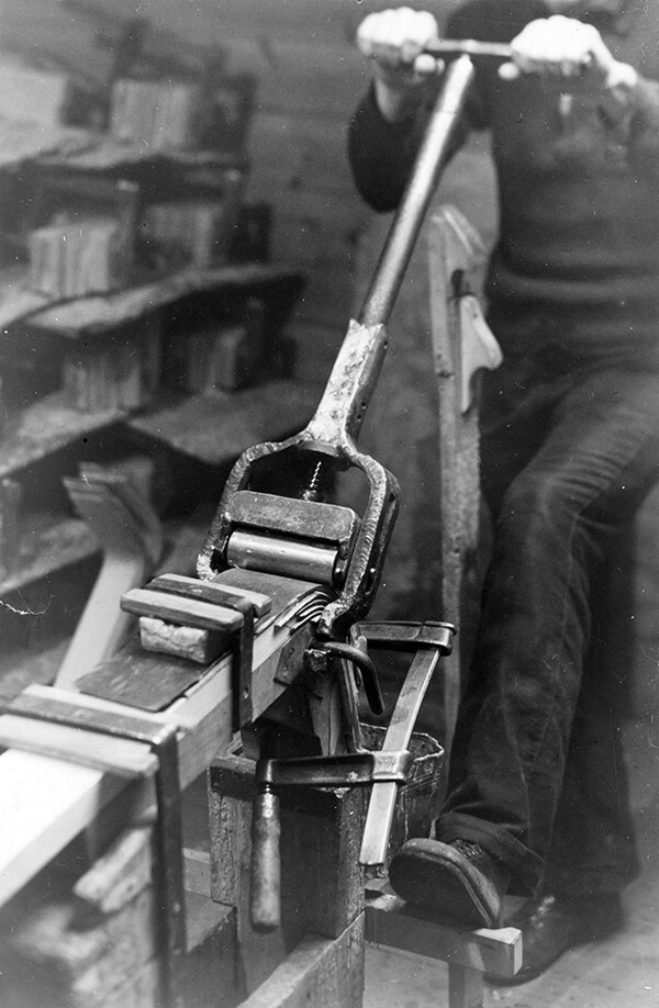 Historical photograph of the birch bending process inside the Artek factory