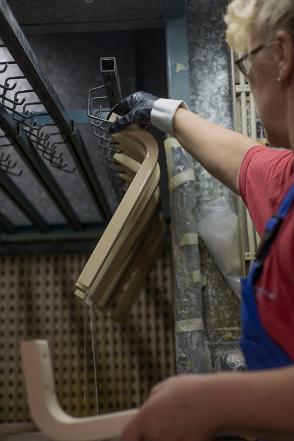 A factory worker hanging up L-legs to dry