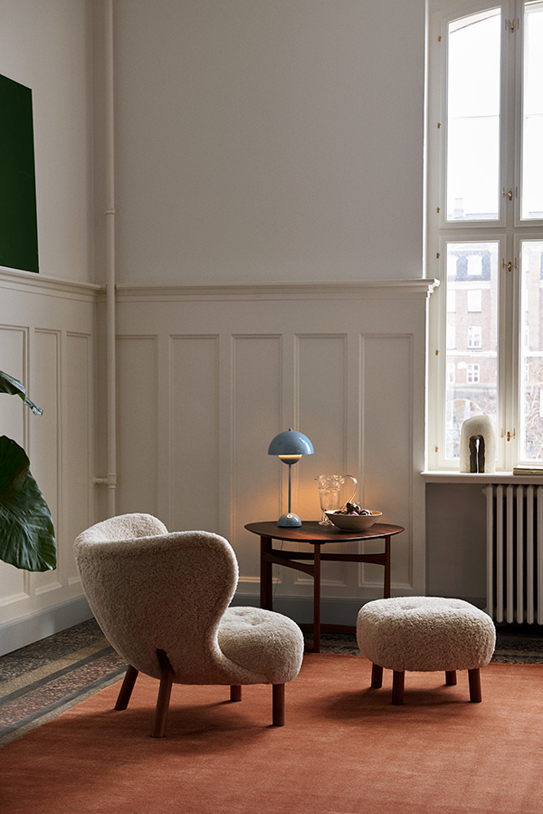 Looking at the back of a Little Petra lounge chair on a red rug