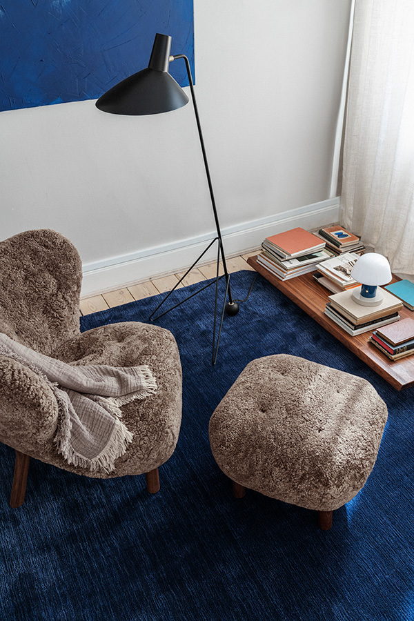 Looking down on the Little Petra lounge chair and pouf on a blue rug