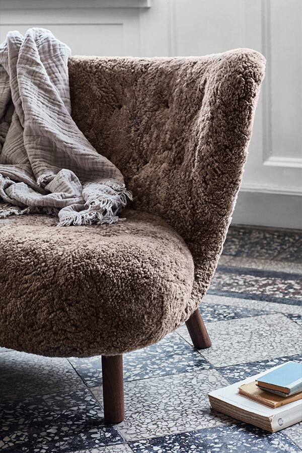 A close up of the sheepskin upholstery on the Little Petra lounge chair