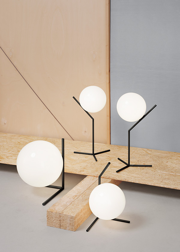 A collection of black Flos IC table lamps against a wooden set