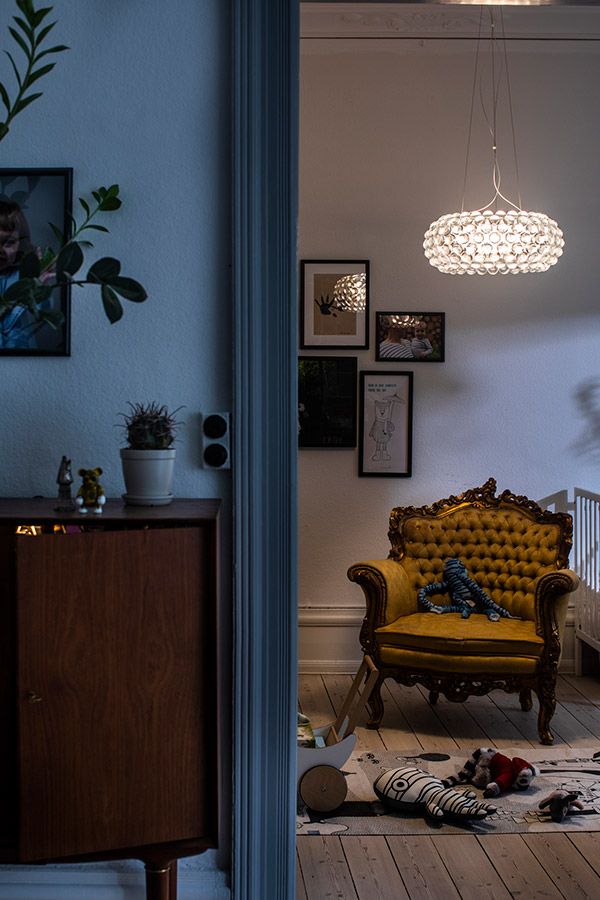 Foscarini caboche pendant above a yellow armchair