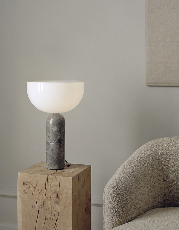 New Works Kizu Table Lamp in grey marble on a wooden side table