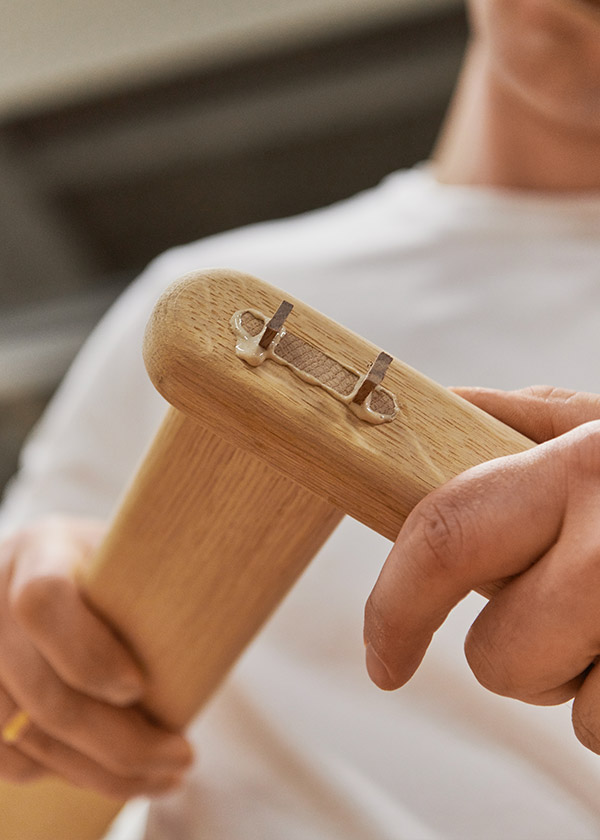 Two parts of the Gubi MR01 Initial Chair being glued together