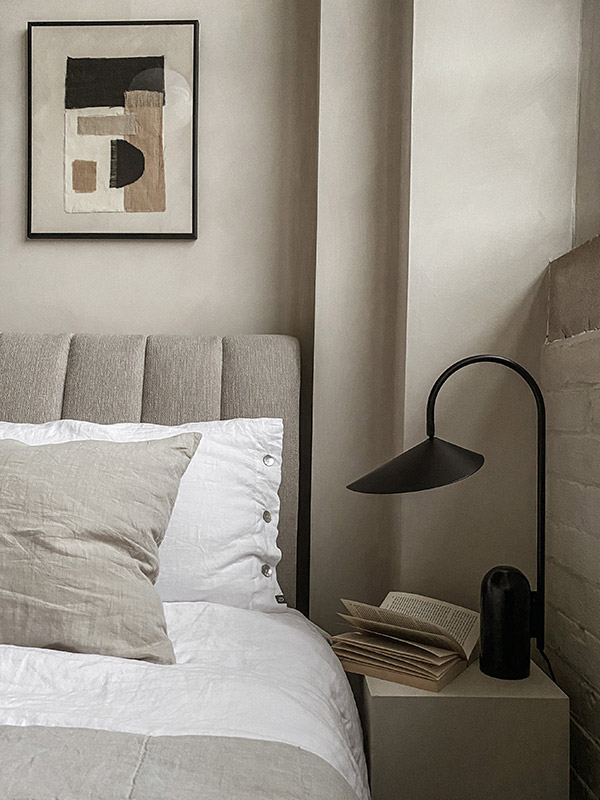 Neutral bedroom with a Ferm Living Arum table lamp on the bedside table