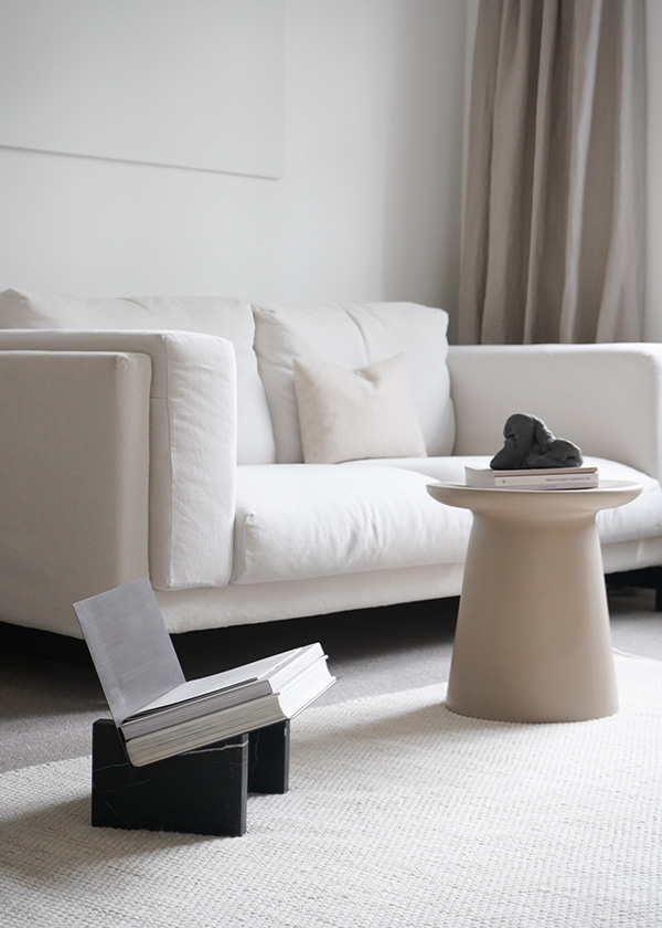 Audo Monument Magazine Holder next to a white sofa