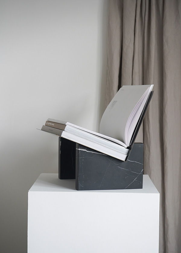 Audo Monument Magazine Holder on a white plinth