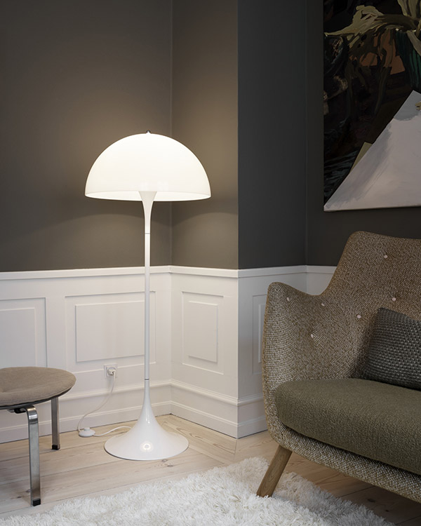 Louis Poulsen Partiella Floor Lamp next to a grey sofa