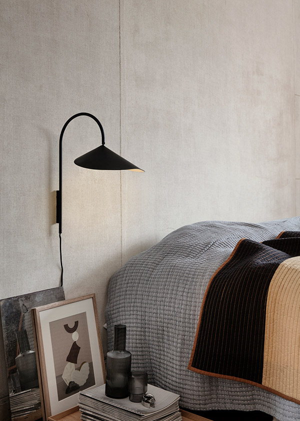 Ferm Living Arum Wall Lamp next to a bed