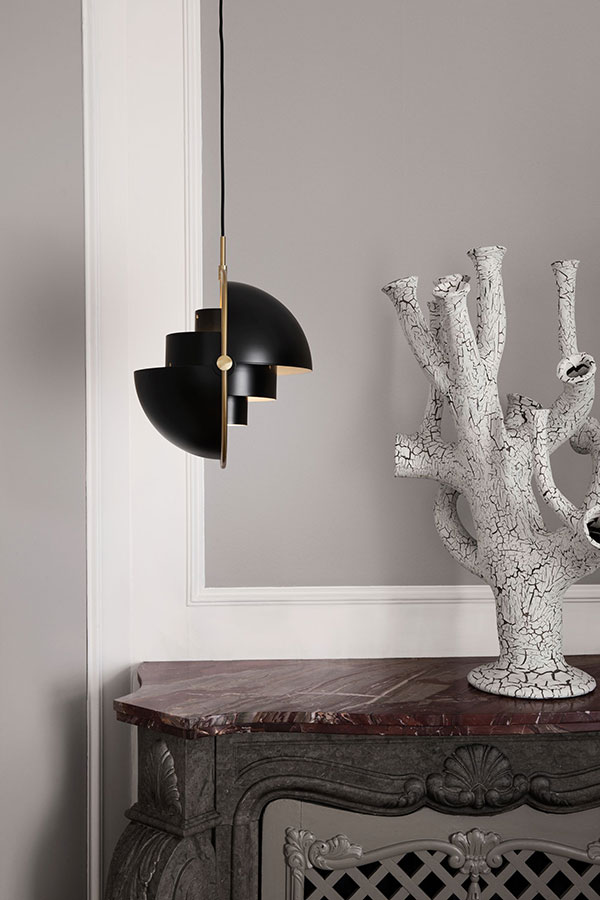 Side view of Gubi Multi-Lite in black and brass