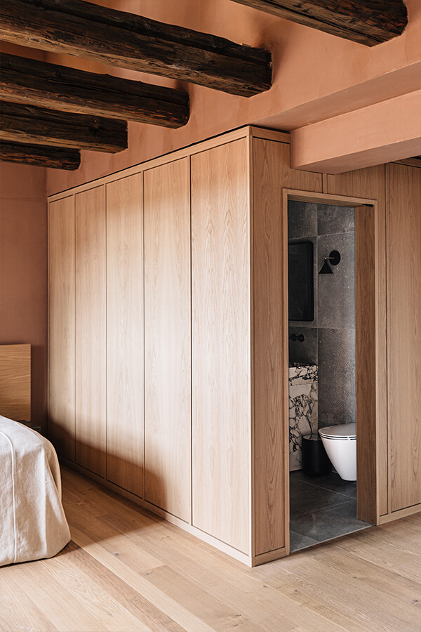 A wooden box encloses the bathroom in a suite at The Audo Residence